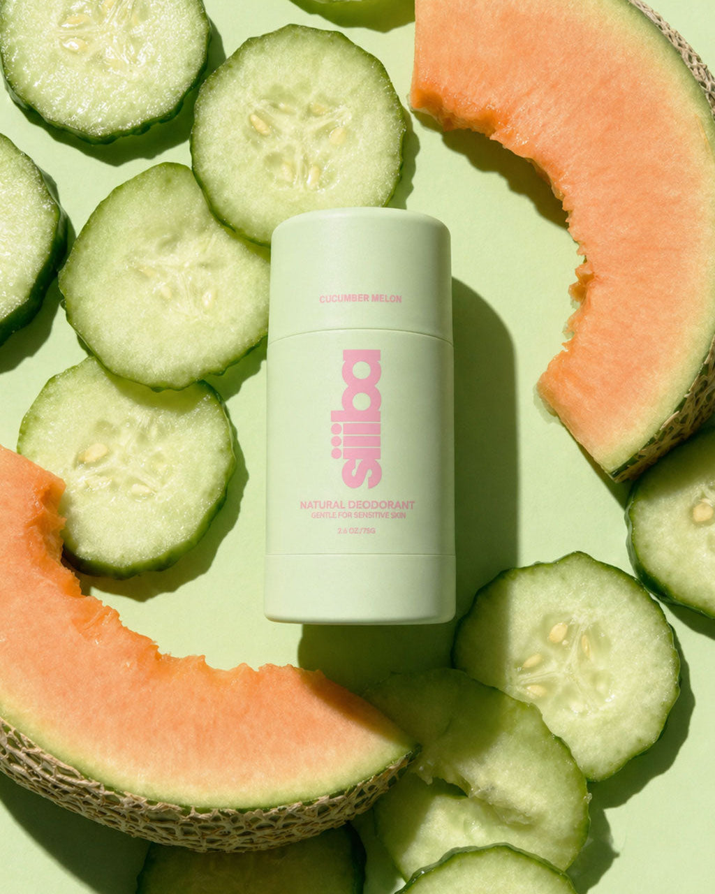Siiiba deodorant product with pink label surrounded by cucumber slices and melon on a green background