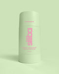 Green deodorant container with pink text on a light green background