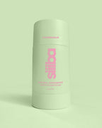 Green deodorant container with pink text on a light green background