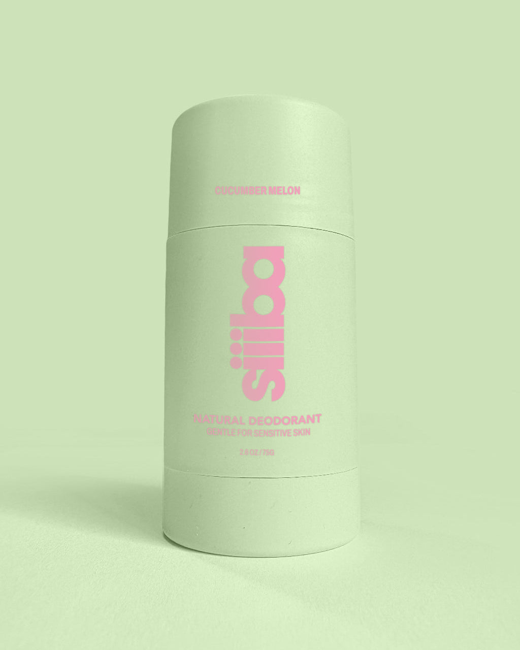 Green deodorant container with pink text on a light green background