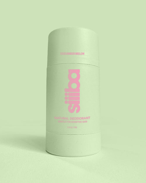 Green deodorant container with pink text on a light green background