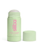 Green deodorant stick with cap on a white background