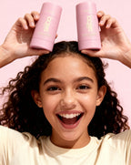 Person holding two pink 'Siiiba' products above their head with a pink background