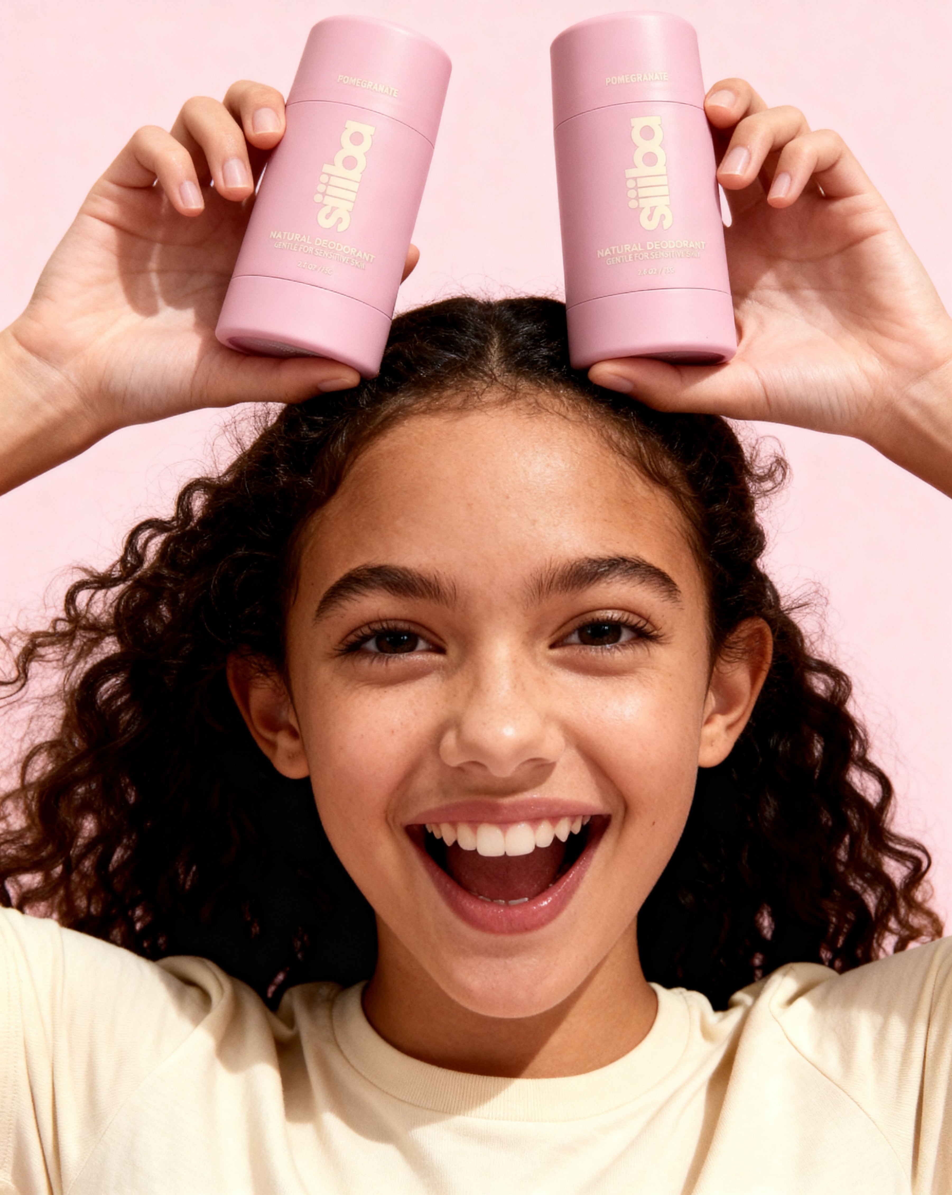 Person holding two pink 'Siiiba' products above their head with a pink background