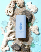 Siiiba natural deodorant stick on a background of coral and seashells