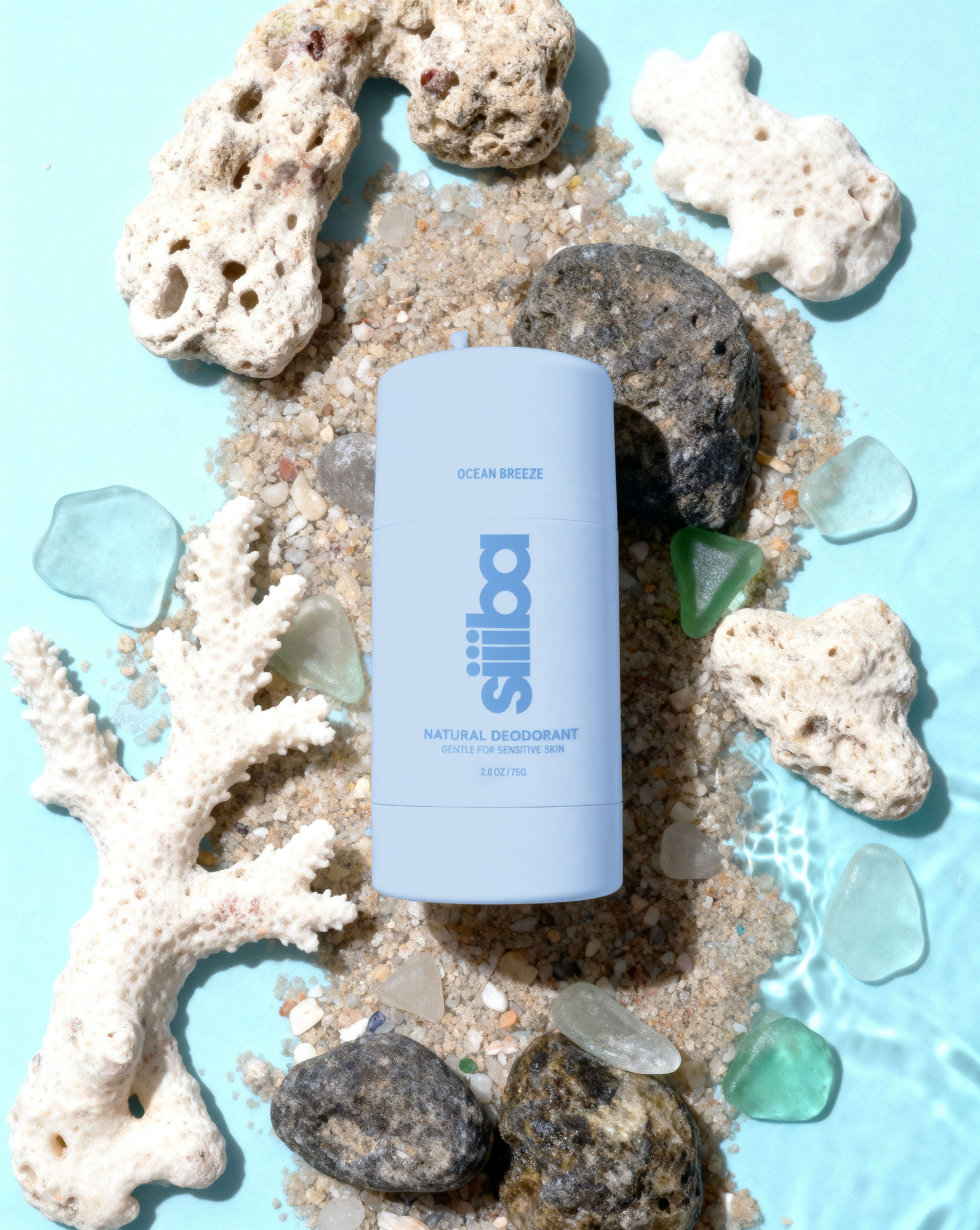 Siiiba natural deodorant stick on a background of coral and seashells