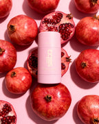 Deodorant stick with pomegranate on a pink background