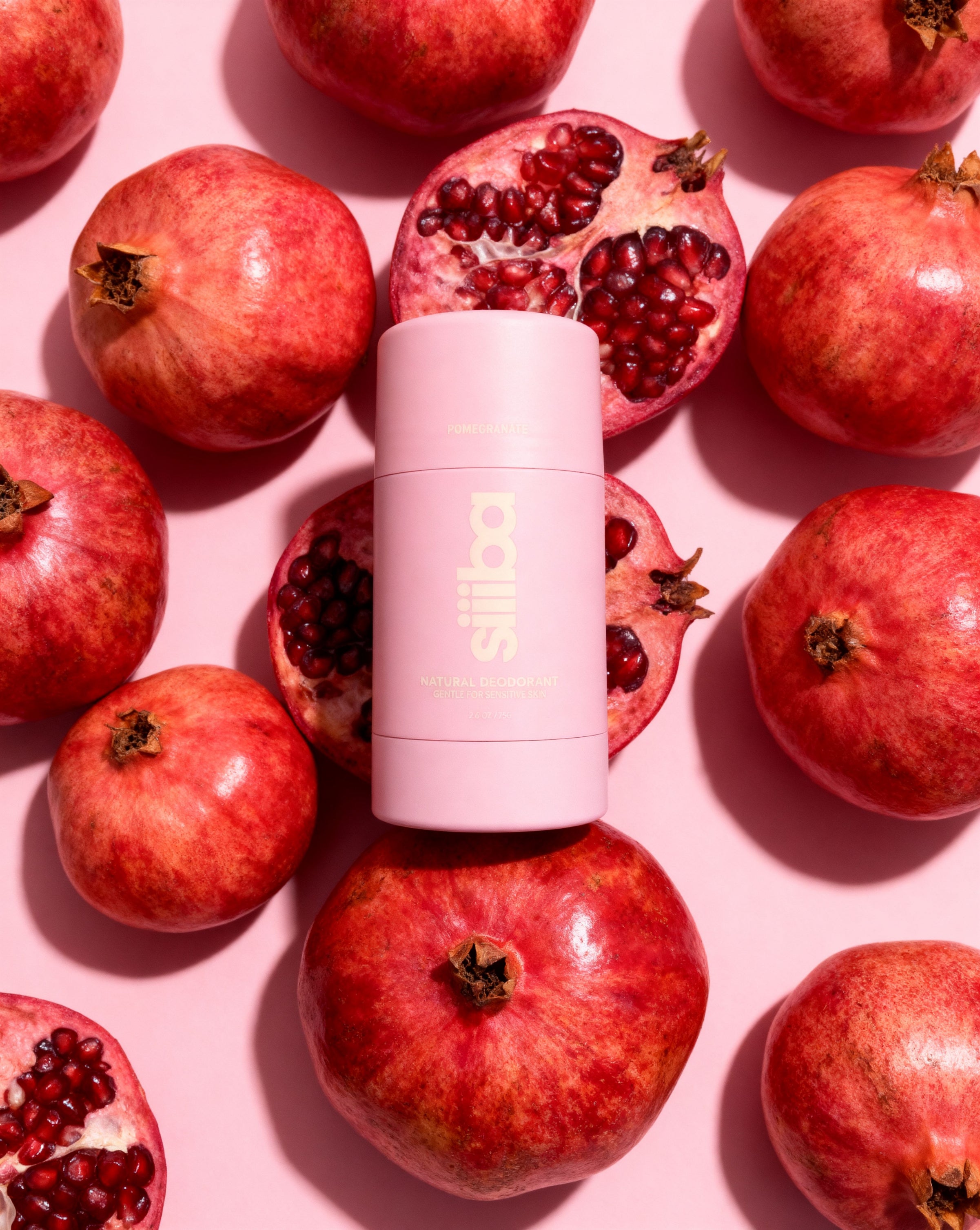 Deodorant stick with pomegranate on a pink background